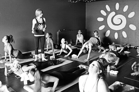 A group of people doing yoga in a room.