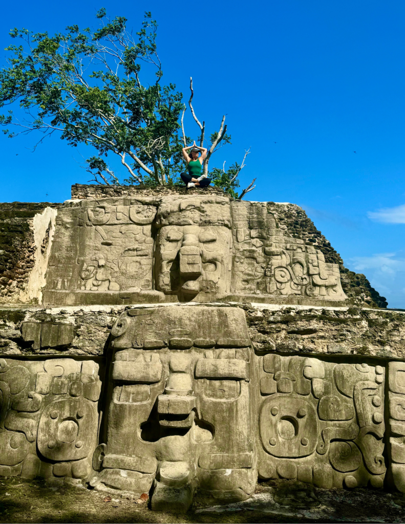 A man is standing on top of an ancient structure.